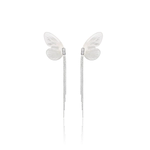 Macro detail of silver butterfly wing tassel earrings with sparkling zircon crystals