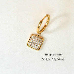 Close-up of golden hoop earrings with white zircon square charm and size specifications