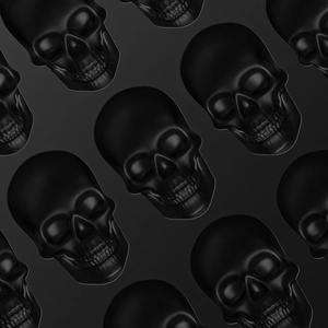Macro shot of embossed black skull pattern on textured silicone baking mold surface