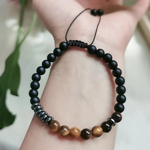 Macro detail of Mother Daughter Morse code bracelet with matte beads and tiger eye stones