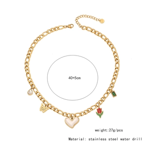Detail of stainless steel gold Cuban link necklace with colorful charms and crystals