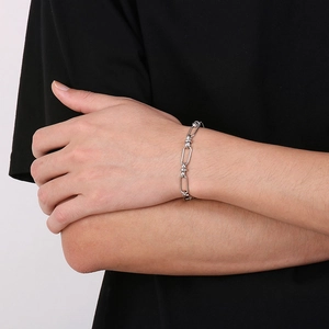 Close-up of minimalist silver stainless steel square link bracelet on model's wrist