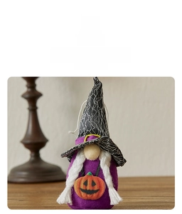 Detail of Halloween gnome plush with purple fabric, pumpkin design and spider web hat