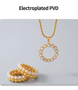 Detail of PVD gold plated jewelry set featuring pearl necklace and stacked rings