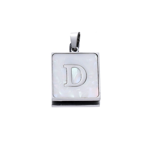 Macro detail of square stainless steel pendant with letter D on white shell