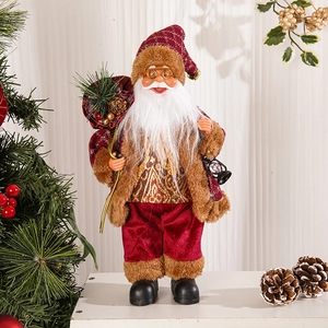 Detail of 12-inch standing Santa figure holding a gold gift bag and lantern ornament