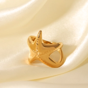 Ocean style 18K gold plated stainless steel starfish ring on cream silk fabric