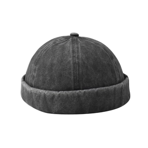 Macro detail of washed denim texture and stitching on a dark grey vintage docker hat