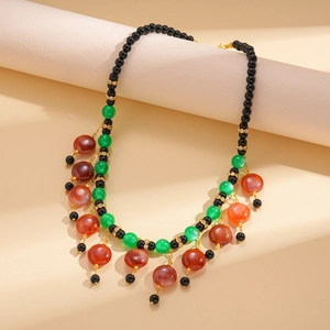 Ethnic style bohemian necklace with multi-colored resin beads and gold metal accents