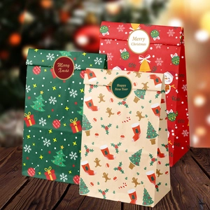 Detail of Christmas gift bags with festive patterns and stickers on a wooden surface
