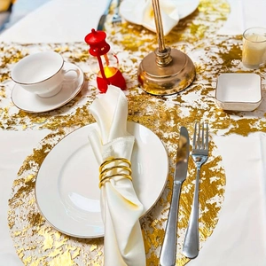 Elegant gold foil mesh table runner and round placemats for wedding and Christmas decor