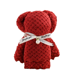 Red coral fleece pineapple lattice towel folded into a bear shape with a pearl ribbon