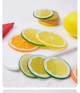Detailed close-up of realistic PVC lemon, lime and orange slices for creative decor
