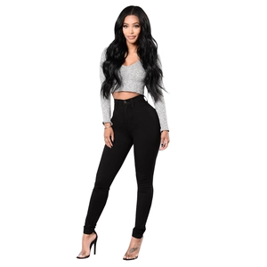 Full view of high waist skinny black jeans paired with grey cropped top on female model