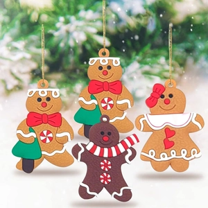 Detailed view of four classic gingerbread man ornaments with golden hanging ropes