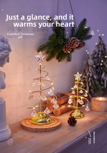 Close-up of golden spiral crystal Christmas tree decorations on a warm wooden surface