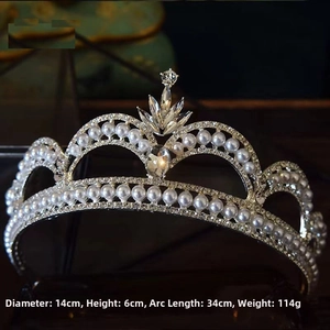 Detail view of silver bridal crown with white pearls and sparkling rhinestones