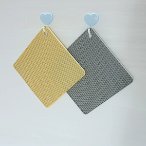 Nordic square silicone honeycomb placemats in yellow and grey colors on hooks