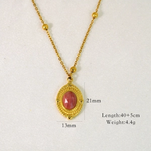 Macro shot of 14K gold stainless steel necklace with pink oval gemstone pendant and sizes