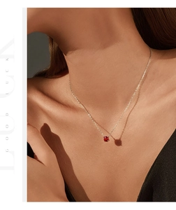 Close-up of elegant S925 silver necklace with red octagon gemstone pendant on model