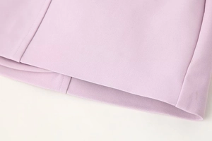 Detailed close-up of lavender dress fabric texture and professional hem stitching quality