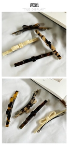 Detailed tile display of French acetate bow hair clips and vintage marble barrettes