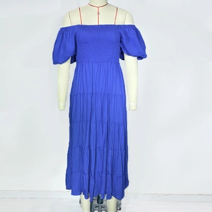 Detail of royal blue tiered maxi dress with smocked bodice and puff sleeves on mannequin