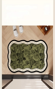 Detail of green floral bath mat with wavy edges and Every One Deserves To Be Loved text