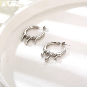 Minimalist silver liquid metal lava earrings with a high-polished melting drop design