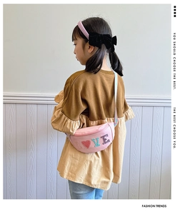 Detailed view of a pink sequin kids waist bag featuring colorful glitter LOVE lettering