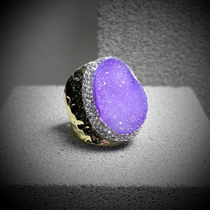 Close-up of a purple druzy quartz ring with a hammered gold-tone textured band