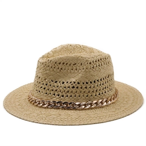 Detail of hand-woven fedora hat with a delicate light gold metal chain decoration