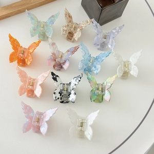 Flat lay of colorful butterfly hair claws in various marble textures and acetates