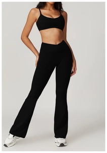Detail of high waisted flared yoga pants with crossover waist and moisture wicking fabric