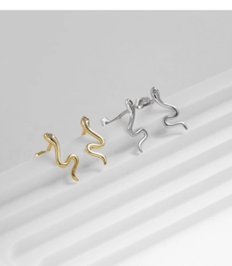 Detailed view of gold and silver S925 snake stud earrings with clear gemstones