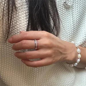 Detail of 925 sterling silver thin rings and irregular freshwater pearl bracelet