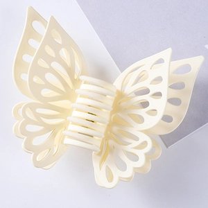 Detail of matte cream double-layer hollow butterfly hair claw clip with frosted texture