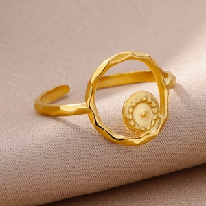 Macro shot of 18k gold plated open ring featuring a textured disc and beaded detail