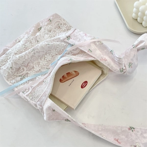 Pink velvet shoulder bag with floral lace detail and contrast ribbon accents