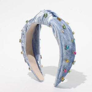 Detail of light blue velvet headband with colorful rhinestones and top knot design