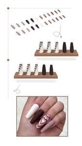 Detail view of long coffin press-on nails featuring leopard print and heart designs