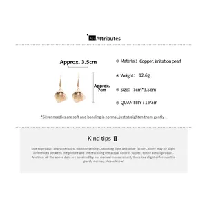Detailed view of hollow leaf earrings with pearls, measuring 7cm by 3.5cm in gold brass