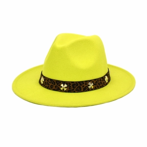 Close-up of leopard band with golden cross metal charms on yellow wool fedora hat