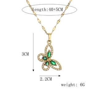 Macro shot of green and white rhinestone butterfly pendant with size dimensions in cm