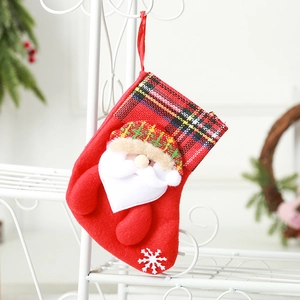 Red Christmas stocking with 3D Santa Claus figure, buffalo plaid cuff and snowflake detail