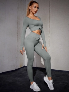 Detail of ribbed gray yoga set featuring thumbhole cuffs and decorative drawstring
