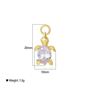 Macro shot of 18k gold plated turtle pendant with dimensions 20mm by 10mm and clear zircon