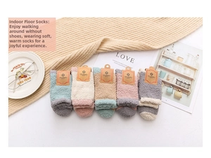 Cozy coral fleece socks set in pastel colors displayed on a warm knitted blanket