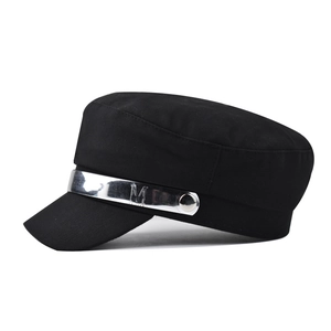 Detail of black cotton military hat with silver metallic band and engraved M letter logo