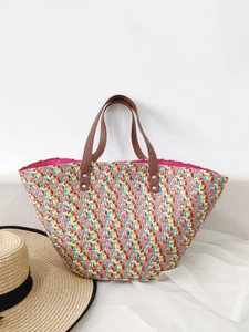 Colorful woven straw tote bag with brown leather handles for summer beach holidays